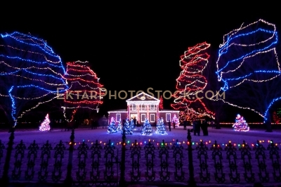 Mansion Front yard decorated with colorful Christmas lights fence