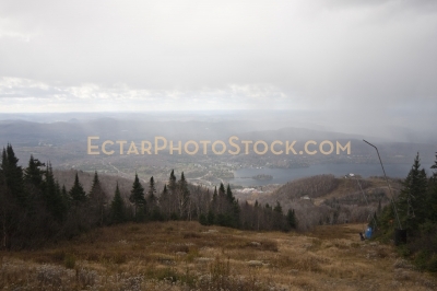 Mont Tremblant lake and snow making towers cloudy sky