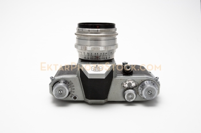 Old film SLR camera isolated on white top view