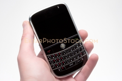 Smartphone isolated on white with hand holding it