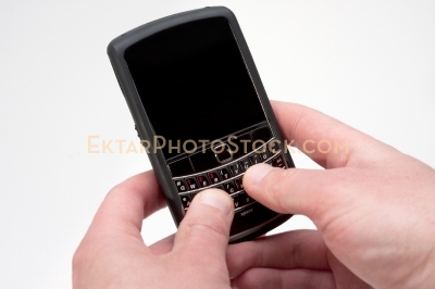 Smartphone isolated on white with hands typing message angle